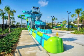 Enjoy thrilling water slides surrounded by lush palm trees and a scenic walkway.