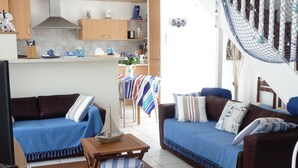 Una sala de estar moderna con un sofá, una mesita de madera y una silla de mimbre.