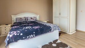 A bedroom with a bed, nightstands, a wardrobe, and a wall-mounted air conditioner. - Two Bedroom Apartment, Terrace in Aphrodite Palace (Sunny Beach)