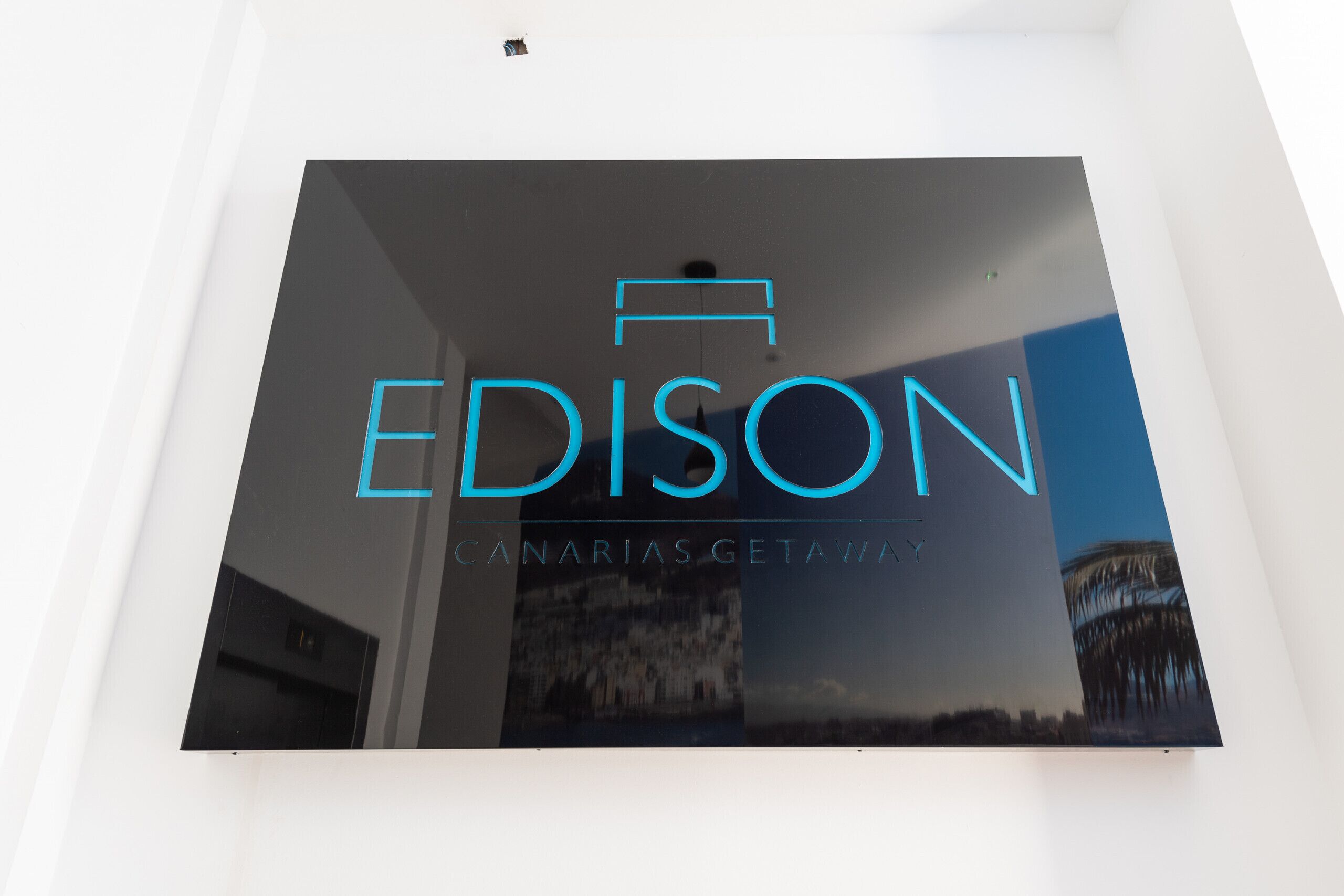 En skylt med namnet ”EDISON” och sloganen ”EN VISTELSE PÅ CANARIEÖARNA”.