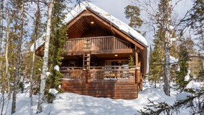 A wooden cabin with a balcony, surrounded by snow-covered trees. - Mervinrinne by Interhome (Sodankylä)