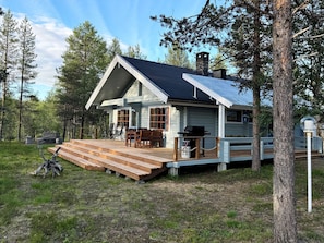 A cabin with a deck, outdoor seating, and a chimney. - Keromaja by Interhome (Inari)