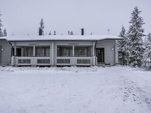 A two-story building with a porch and a covered entrance. - Rukannaava 1b (12) by Interhome (Kuusamo)