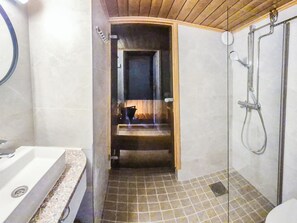 A bathroom with a shower, a sink, and a toilet.