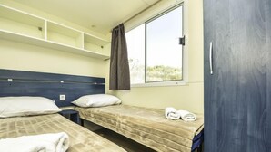 A dormitory room with two beds, a window, and a wardrobe. - Vacation home Palma by Interhome (Novigrad (Zadar))