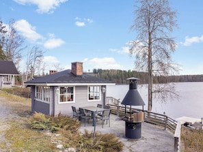 A lakeside cabin with a deck, outdoor seating, and a chimney. - Rahkola by Interhome (Ikaalinen)