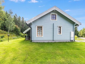 A single-story house with a gabled roof, a front porch, and a well-maintained lawn. - Yläperho 2 by Interhome (Sotkamo)
