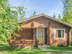 A wooden cabin with a front porch, a door, and a small window. - Iltarusko by Interhome (Savonlinna)