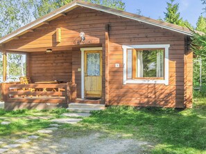 A wooden cabin with a front porch, a bench, and a door labeled 'ILTAARUSKO'. - Iltarusko by Interhome (Savonlinna)