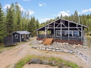 A cabin with a deck, a smaller cabin, and a dirt path. - Kalliolaakso by Interhome (Ikaalinen)