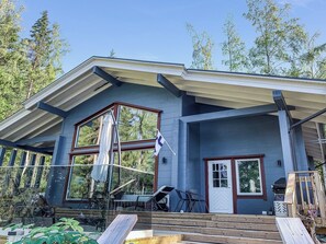A modern house with a large porch, a flag, and a deck. - Klippan by Interhome (Ruovesi)
