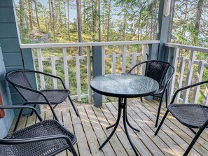 A wooden deck with a round table and four chairs. - Klippan by Interhome (Ruovesi)