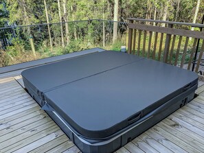 A black mattress on a wooden deck with a metal railing. - Klippan by Interhome (Ruovesi)