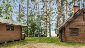 A rustic cabin with a dirt ground and a small grassy area in front. - Auringonlasku by Interhome (Punkaharju)
