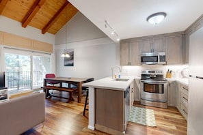 Enjoy cooking in this well-equipped kitchen with a central island, sink, oven, and microwave.