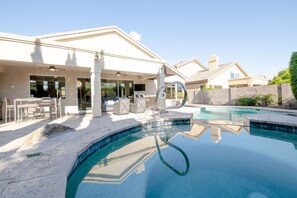 Relax by the pool surrounded by a spacious deck and comfortable outdoor seating.
