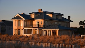 A large, two-story house with a balcony and a covered porch.
