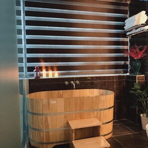 A wooden sauna with a bench, a glass door, and a shelf with candles and a vase. - Mio Hotel (Hai Phong)
