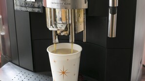 A coffee machine dispensing espresso into a cup. - Hisai Green Hotel (Tsu)