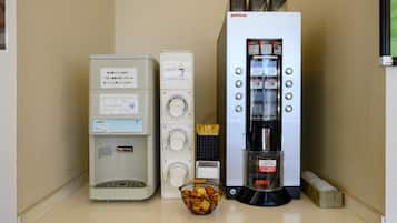 A kitchenette with a coffee machine, a rice cooker, and a small refrigerator.
