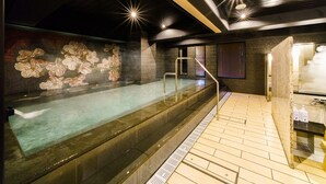 A spa area with a hot tub, tiled flooring, and a wall with a floral mural. - Super Hotel Ikebukuro-Eki Kitaguchi (Tokyo)