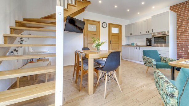 A modern kitchen with white cabinets, a built-in oven, and a coffee machine. - Siglanów by Interhome (Wisla)