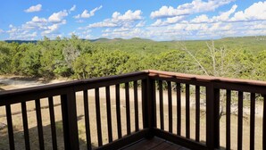A wooden deck with a view of green hills and a clear sky. - Beautiful Zen Temple Home on Canyon Lake! (Canyon Lake)