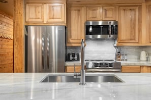 Enjoy cooking in this fully equipped kitchen with a refrigerator, microwave, and oven.