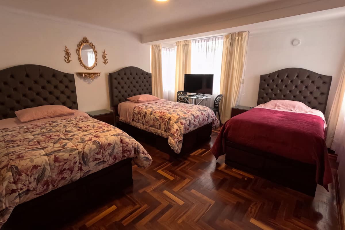 Family Triple Room, Ensuite, Courtyard View | Minibar, individually decorated, individually furnished