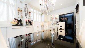 A modern kitchen with white cabinetry, a black refrigerator, and a chandelier. - 5* Luxury Spacious Apartment (Mitcham)