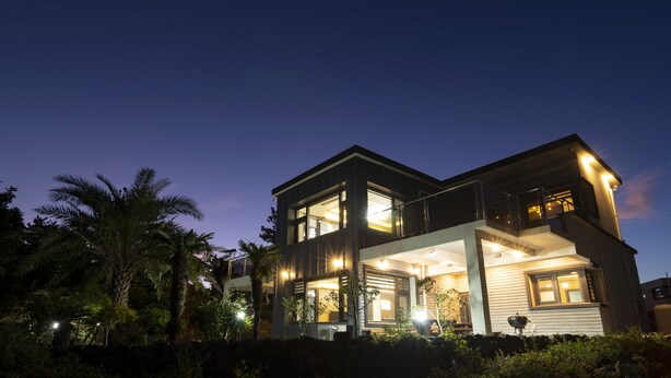 A modern two-story house with large windows and balconies, surrounded by lush greenery. - The Some Plus Onpyeong (Seogwipo)