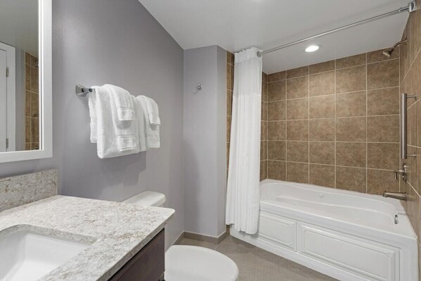 A bathroom with a bathtub, a toilet, a sink, and a shower.