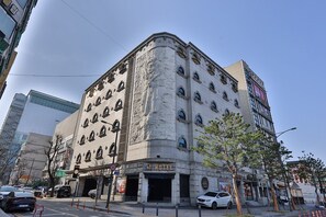 A corner building with a hotel sign, multiple windows, and a visible entrance. - Hotel Sopoong (Incheon)