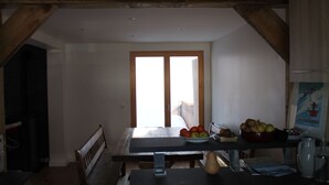 A dining area with a wooden table, benches, and a bowl of fruit. - Chalet adjoining Les Contamines-Montjoie, sleeps 10 (Les Contamines-Montjoie)