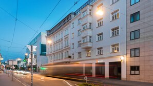 A modern building with a flat facade, large windows, and a ground-level entrance. - master Mirabell (Salzburg)