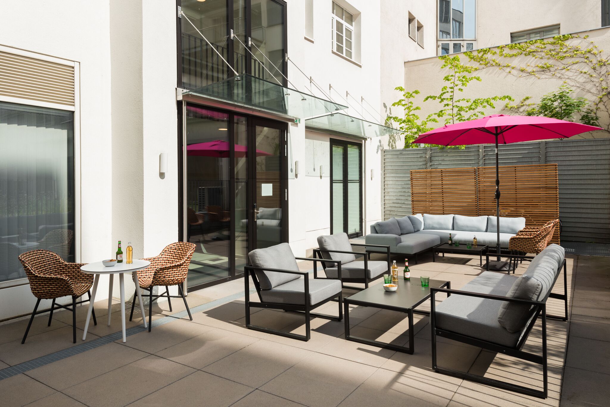 An outdoor patio with a sofa set, chairs, and a table.