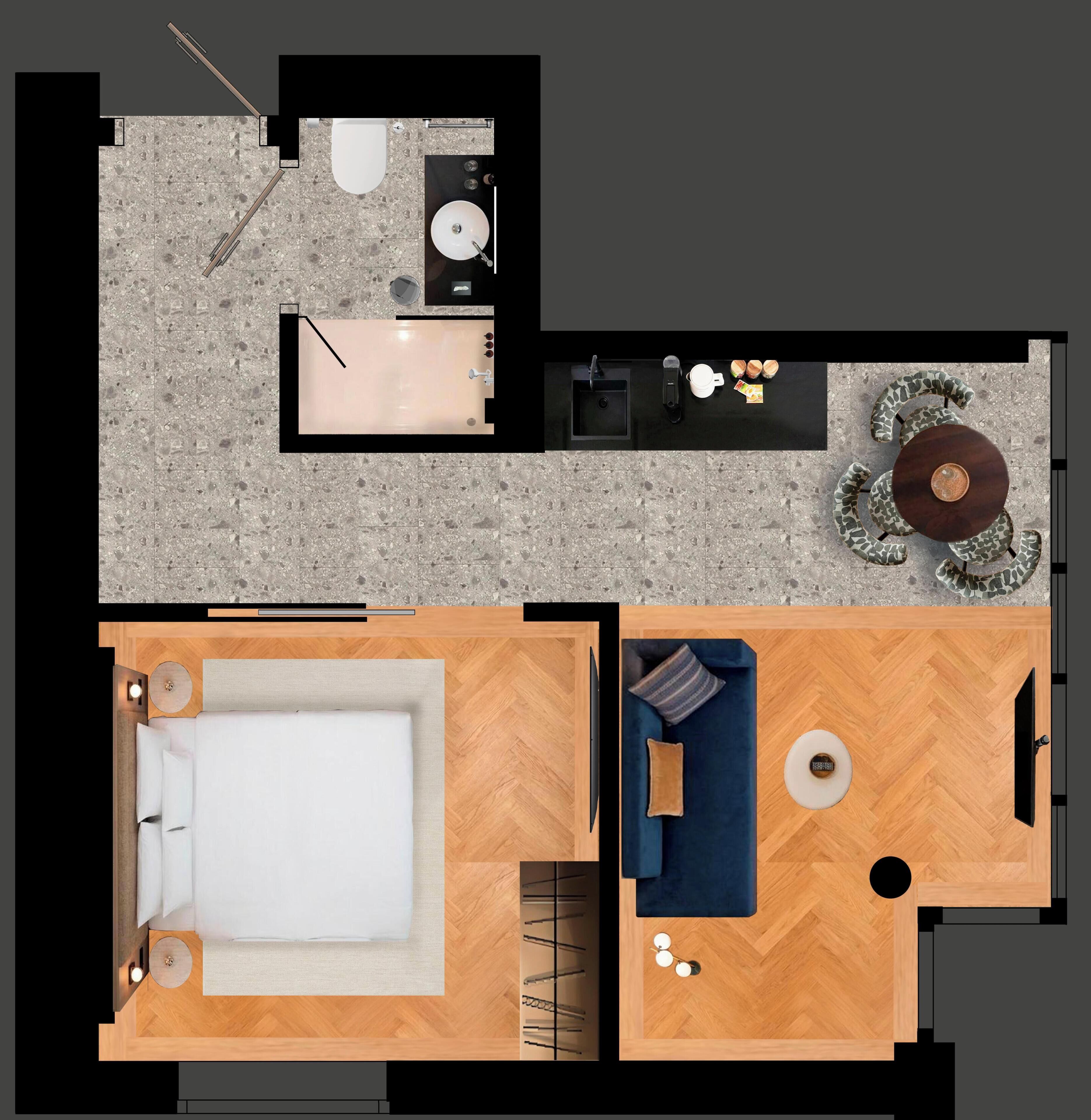 A room with a bed, a small seating area, a kitchenette, and a bathroom.