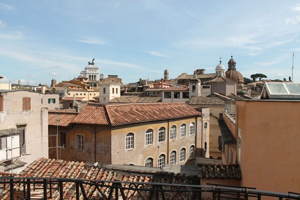 A historic urban area with traditional architecture, including buildings with tiled roofs and arched windows.