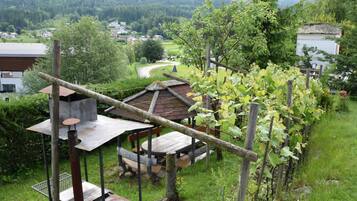 Relax in a serene outdoor seating area surrounded by lush greenery and a picturesque view.