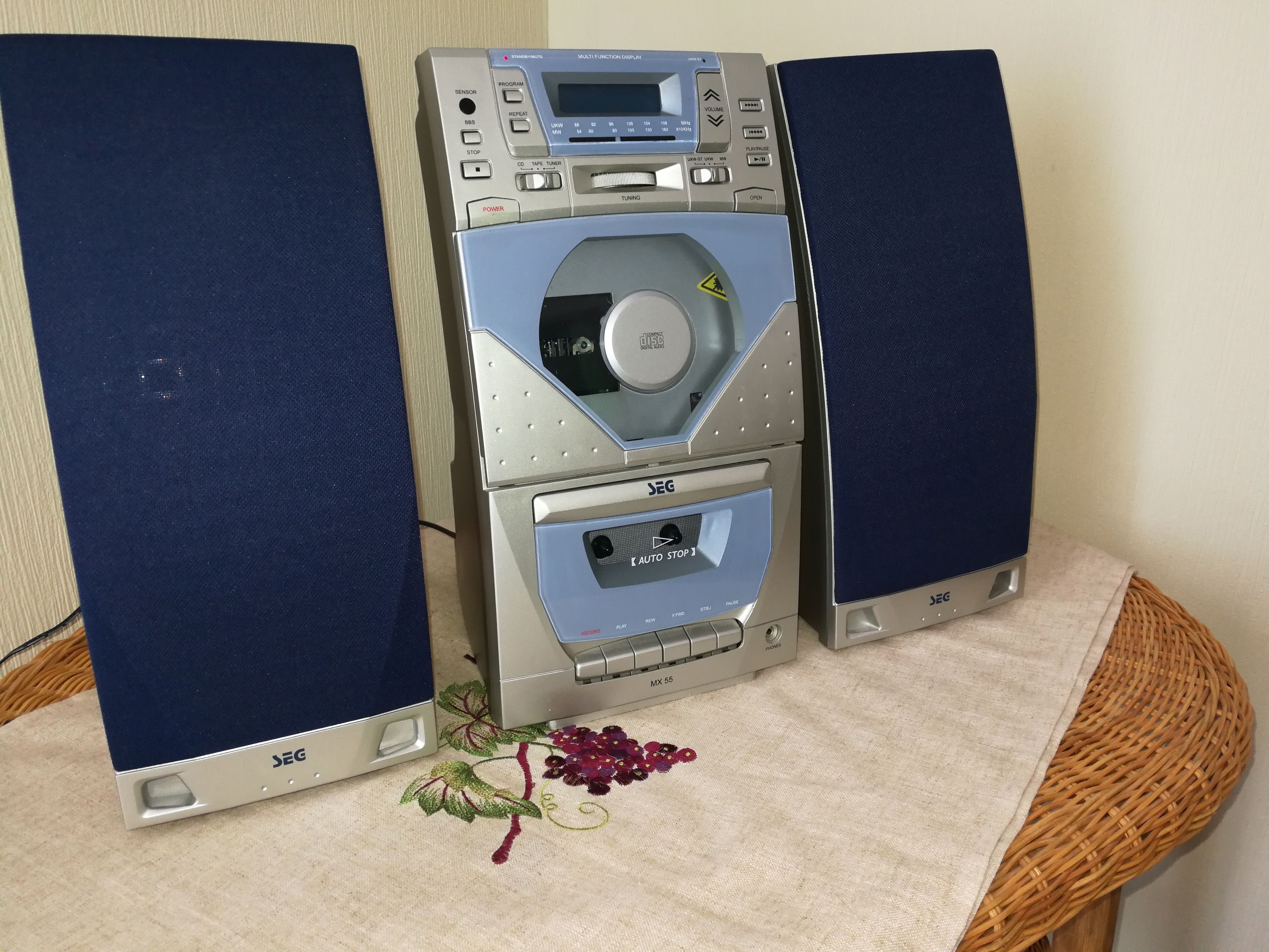 A stereo system with a digital display, buttons, and a cassette tape slot.