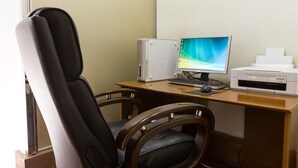 A computer desk with a monitor, keyboard, and printer. There are two chairs and a window in the background. - Hotel Okus Kumamoto (Kumamoto)