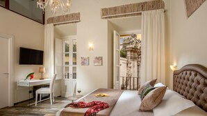 A bedroom with a bed, a desk, a chair, and a television. - MySuite Tower Pantheon (Rome)