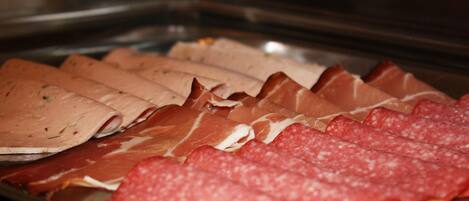 A variety of sliced meats on a tray.