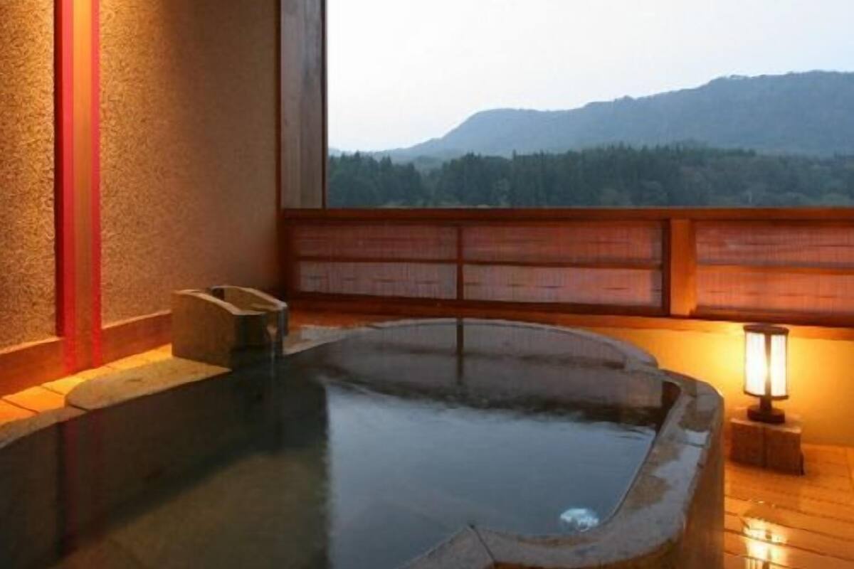 A hot spring bath with a view of mountains.