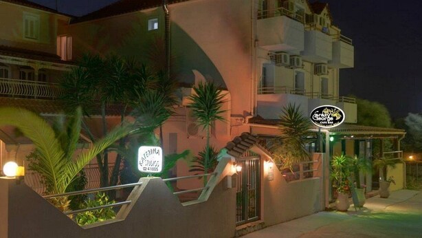 A building with a sign for 'Hotel Riviera' and 'George's Cafe Bar'. - Katerina Studios (Kefalonia)