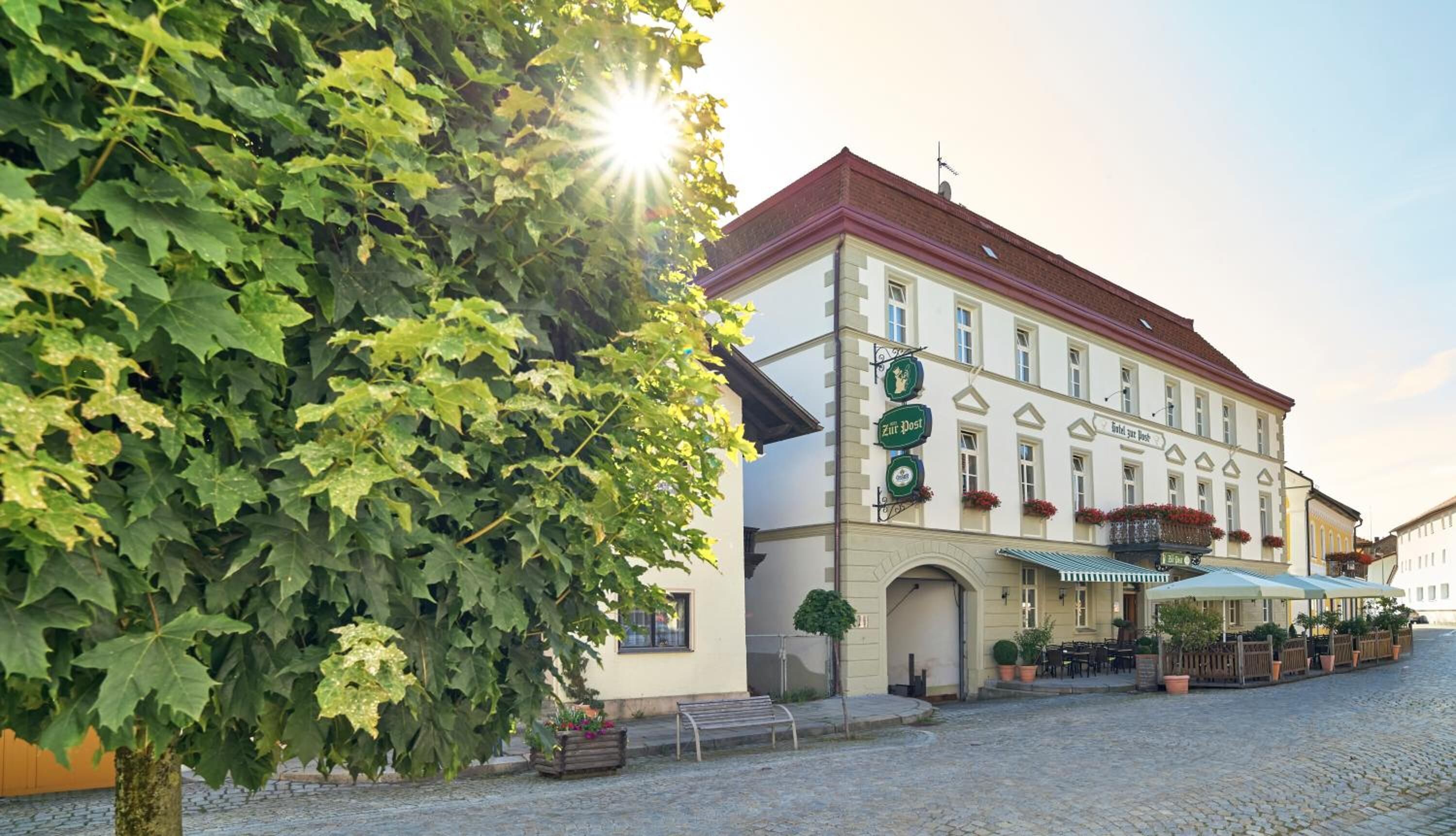 A traditional European building with a sign for 'Zit Post' and a cobblestone street.