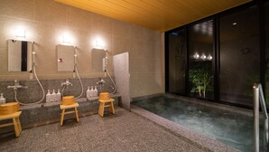 A modern bathroom with a steam shower, granite countertops, wooden stools, and a large window. - Super Hotel Sakai Marittima (Sakai)