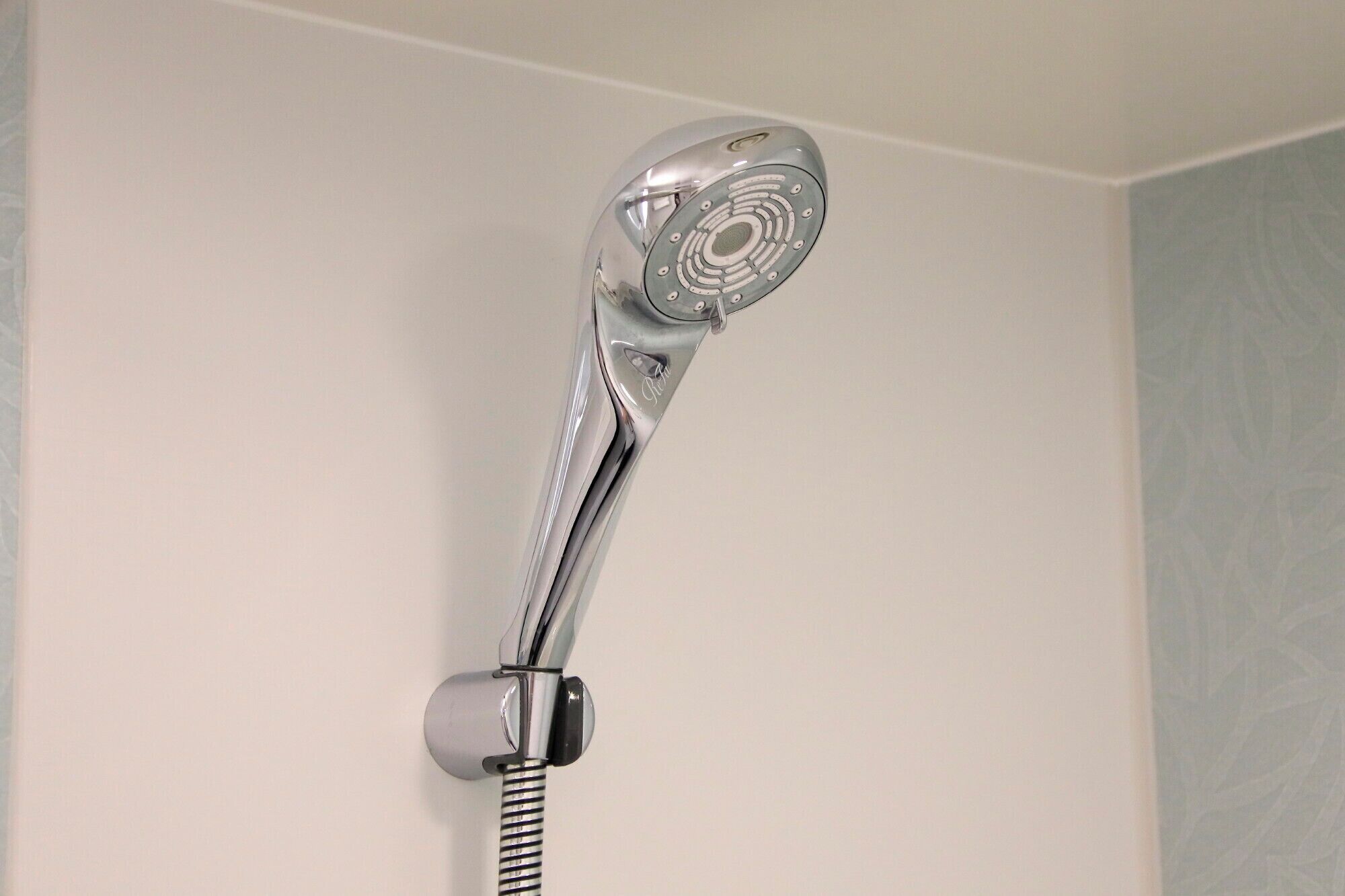 A showerhead with a curved design and a single-handle control.