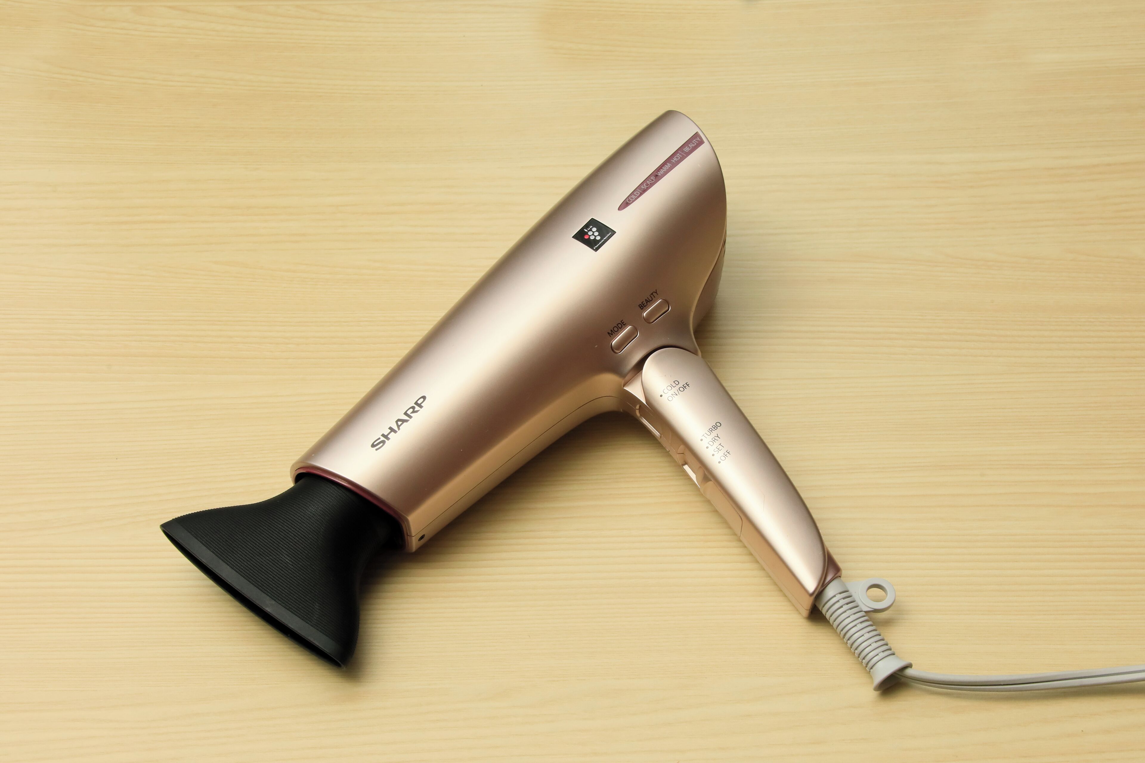 A hair dryer with a sleek design and a metallic finish.