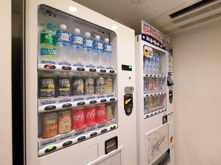 Two vending machines with various beverages and snacks.